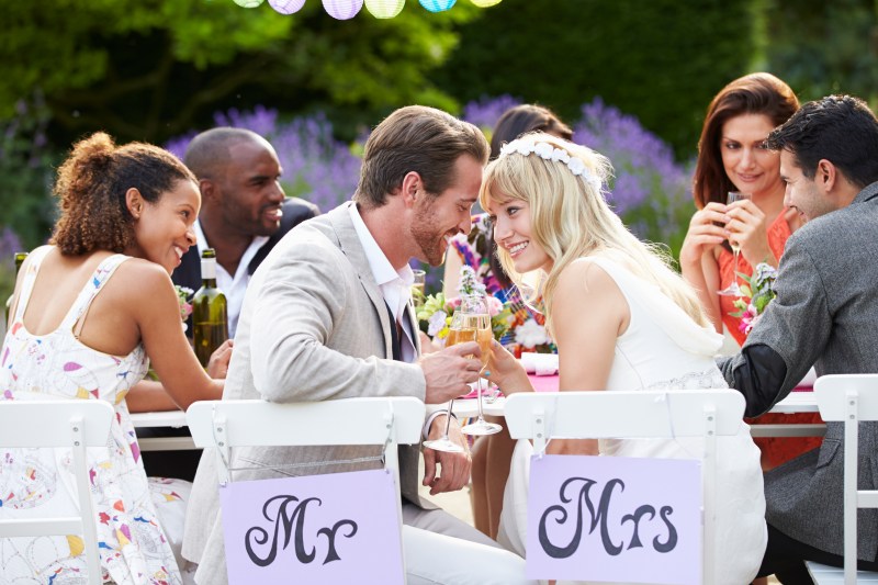 Bride And Groom Enjoying Meal At Wedding Reception